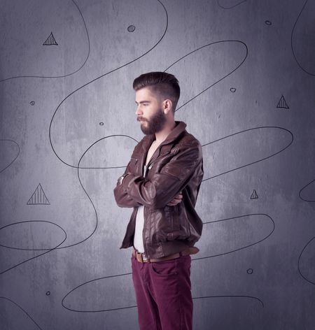 A modern young male in casual fashion style clothing making funny facial expressions while standing