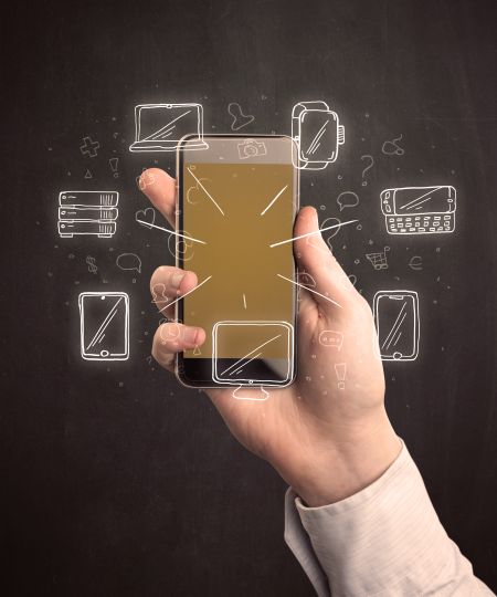 Caucasian hand in business suit holding a smartphone with hand-drawn icons
