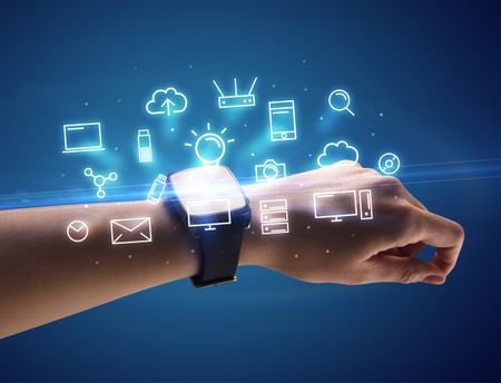 Close up female hand with smartwatch and multimedia symbols around and blue background
