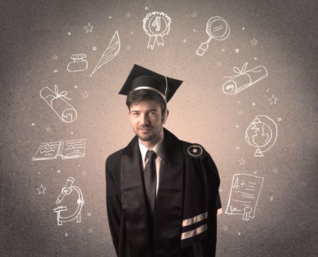 Happy graduate teenager with hand drawn school icons above his head