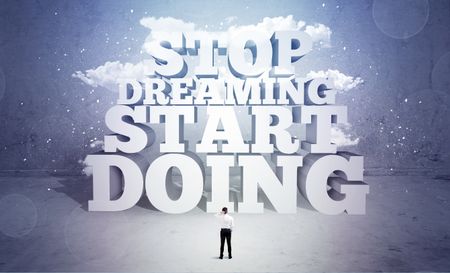 A lazy sales person standing in emty space with huge block letters illustration saying stop dreaming start doing and clouds concept