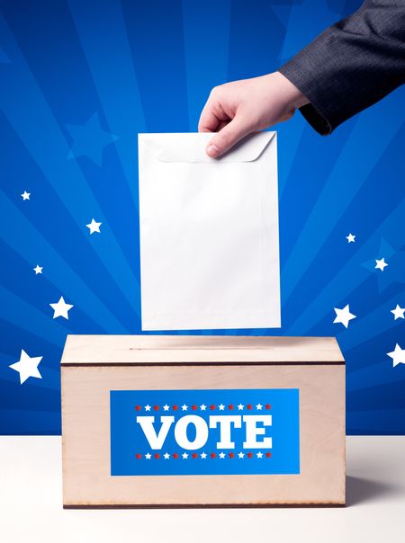 Voting hand with ballot and wooden box