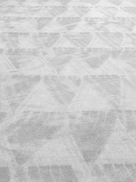 Vacuum pattern on thick white carpet in convention center
