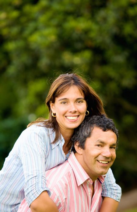 happy and energetic couple portrait outdoors with plenty of copyspace