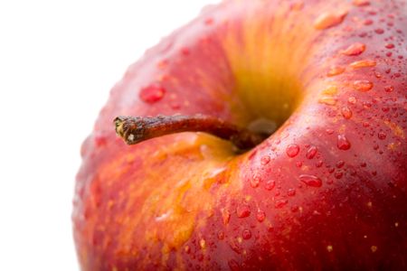 apple in red with drops on its surface isolated over a white background