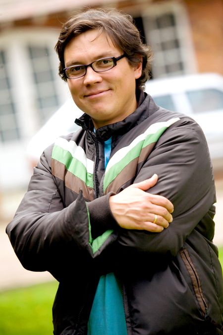 casual successful man portrait wearing glasses and a leather jacket