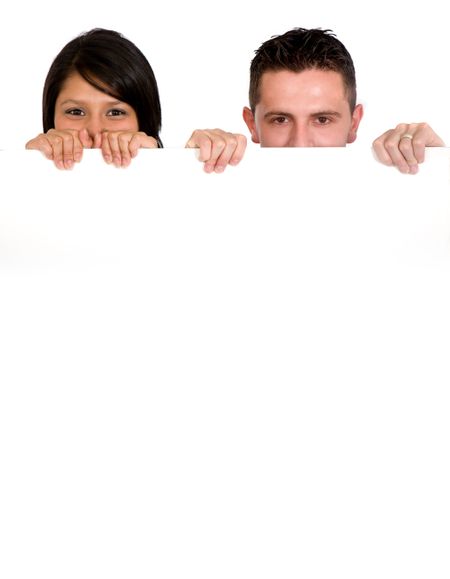 couple holding a white billboard isolated over a white background