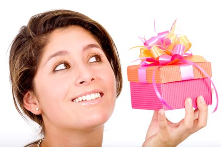girl holding a pink gift box with a whisful look on her face - isolated over a white background