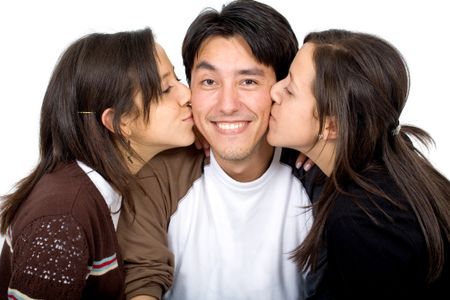 twins kissing a man on both sides of his face - isolated over a white background