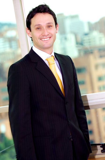 confident and funky business man portrait in an office by the window  where you can see the city in the background