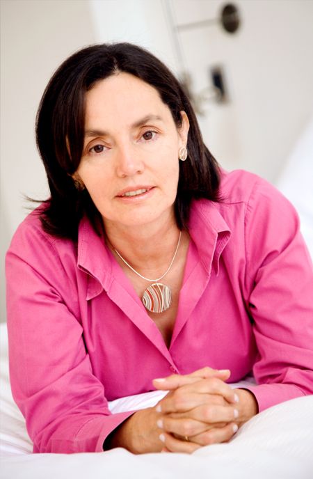 business woman relaxing in a home environment and wearing a pink blouse