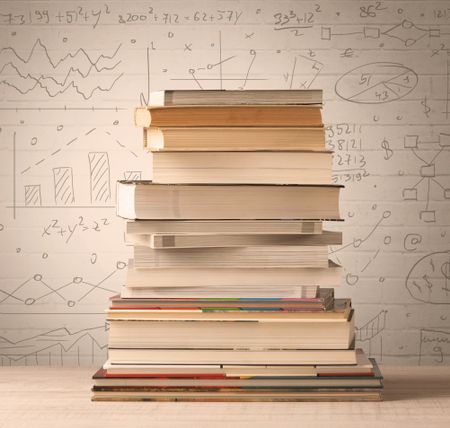 A pile of books with math formulas written in doodle style on background