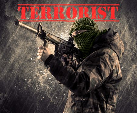 portrait-dangerous-masked-armed-man-terrorist-666132052 Portrait of dangerous masked and armed man with terrorist sign on grungy background