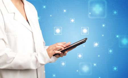 Female doctor holding tablet with blue background and crosses