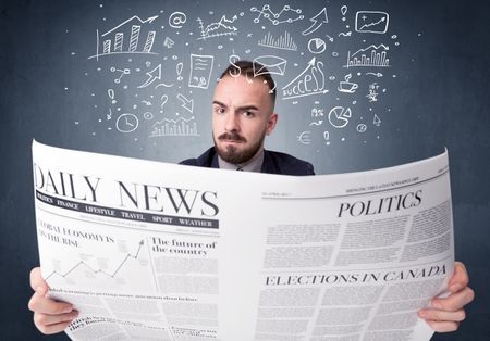 Young smart businessman reading daily newspaper with business plan graphics above his head