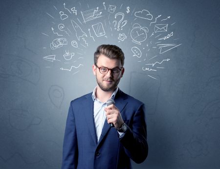 Businessman speaking into microphone with mixed doodles over his head