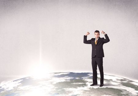 A young elegant office worker standing on top of a drawn world globe while celebrating his successful career concept.