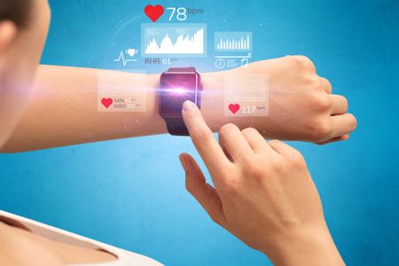 Female hand with smartwatch and health application icons nearby. 