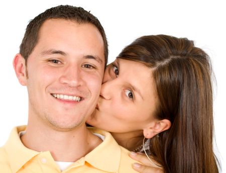 couple portrait where the girl kissing her boyfriend isolated over a white background