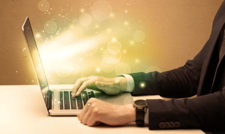 An elegant businessman sitting at desk and pushing the buttons of his laptop keyboard while working very fast illustration concept