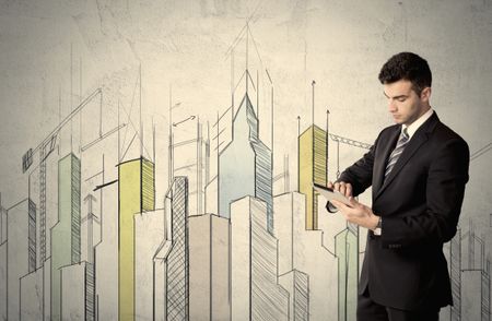A young adult businessman standing in front of a wall with colorful drawings of buildings, charts, graphs, signs