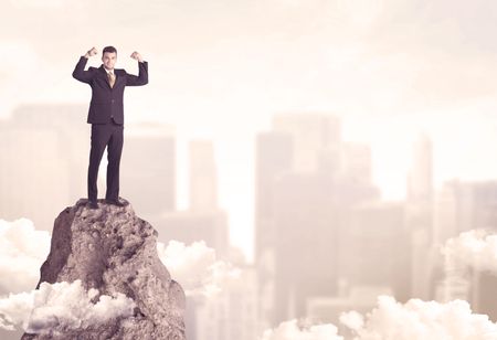 professional-winner-business-person-standing-dangerous-667148914 A professional winner business person standing on a dangerous mountain top above the city scape with clouds concept