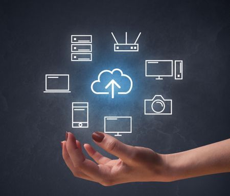 Cloud and computing related icons hovering over young hand 