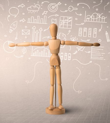 Wooden mannequin posed in front of a greyish background with white scribbled data around him