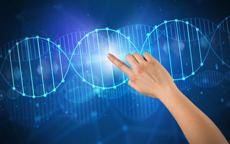 Female hand touching DNA molecule with blue background 