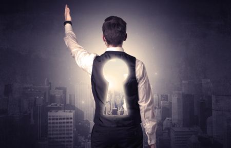 Young businessman standing and thinking with keyhole on his back and city graphic around