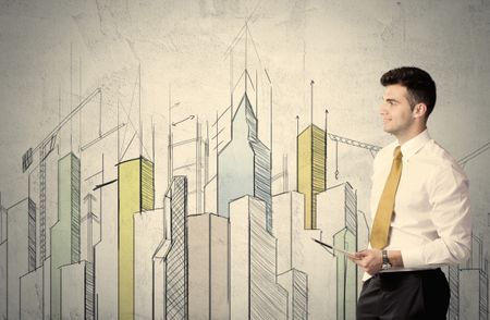 A young adult businessman standing in front of a wall with colorful drawings of buildings, charts, graphs, signs