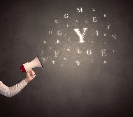 Caucasian arm holding megaphone with letter cloud