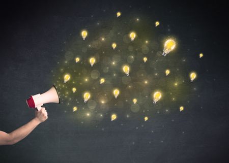 Caucasian business hand holding megaphone with yellow lightbulbs