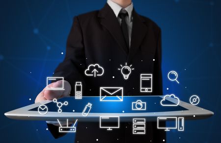 Businessman holding tablet with multimedia icons