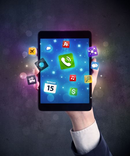 Caucasian hand in business suit holding a smartphone with colorful media icons