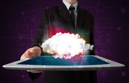 Businessman holding tablet with cloud icon and purple background