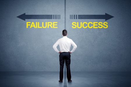 Businessman standing in front of success and failure arrow concept on grungy background