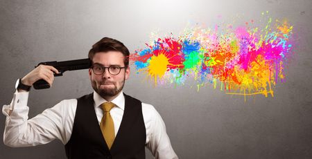 Man shoots his head with gun and colorful splotch are coming out from his head