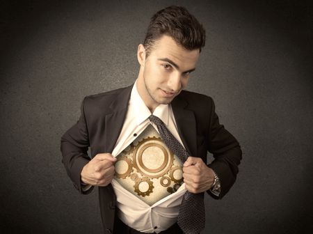 Businessman tearing shirt off and machine cog wheel shows on his chest concept on background