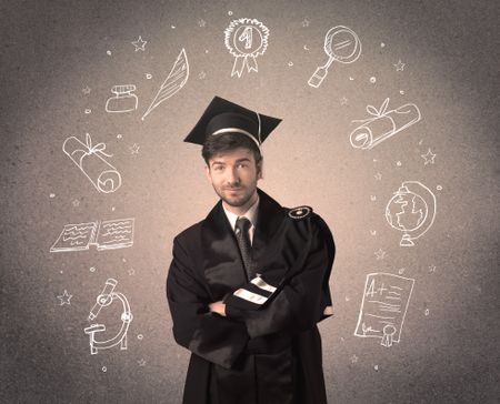 Happy graduate teenager with hand drawn school icons above his head