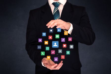 Colorful multimedia icons in the hands of a businessman