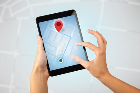 Female fingers touching tablet with map