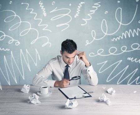 An elegant businessman sitting at office desk and working on keyboard with drawn curves, lines illustration on background wall concept