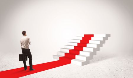 successful-businessman-briefcase-standing-red-carpet-673898602 A successful businessman with briefcase standing on red carpet in front of steps in white space concept