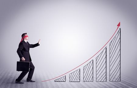 A young male office worker trying to find the right solution to develop a growing market concept with drawn exponential arrow.