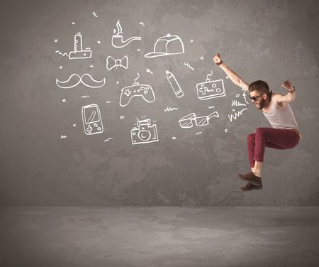 A funny hipster person in casual urban clothing shouting drawn everyday items like camera, tie or pen on city wall concept