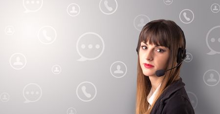 Young female telemarketer with white speech bubbles around her