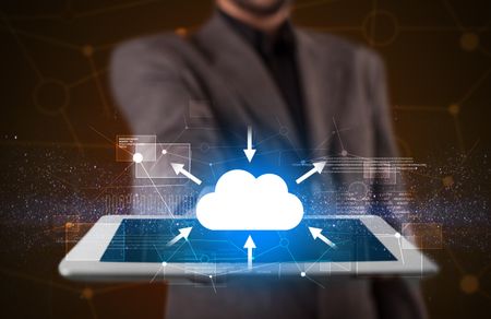 Businessman holding tablet with cloud concept