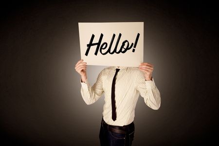 Young businessman hiding behind a greeting drawn on paper