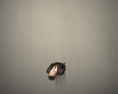 young-businessman-contemplating-decision-standing-grey-675540721 Young businessman contemplating a decision standing on a grey surface